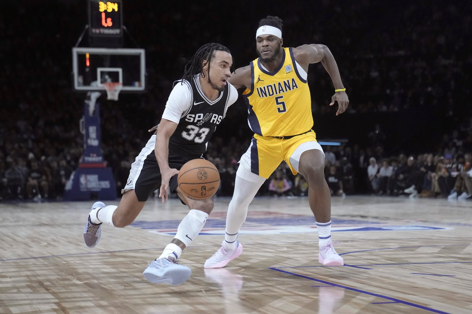 San Antonio Spurs guard Tre Jones (33) drives to the basket against Indiana Pacers forward Jarace Walker (5) during the second half of a Paris Games 2025 NBA basketball game in Paris, Thursday, Jan. 23, 2025. (AP Photo/Thibault Camus)