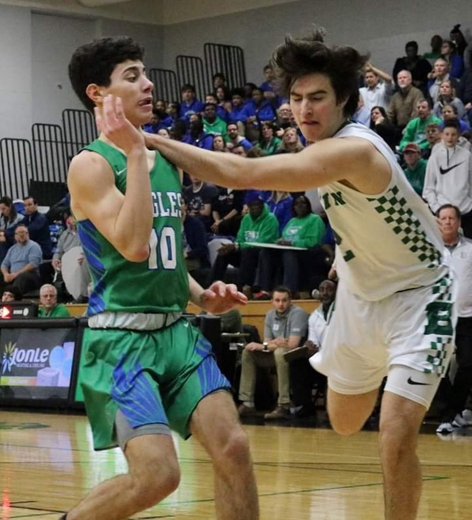 Badin’s Seth Hargis (2) makes contact with Chaminade Julienne’s Jack Nauseef (10) during Friday night’s game at Mulcahey Gym in Hamilton. CJ won 58-54. CONTRIBUTED PHOTO BY TERRI ADAMS