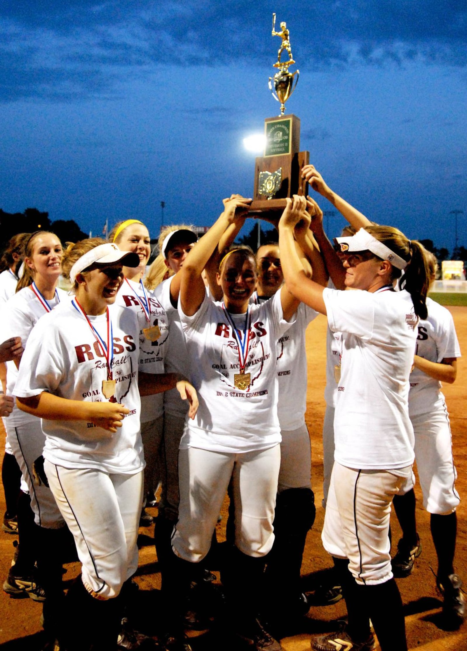 Ross High School’s softball team hoists the Division II state championship trophy June 6, 2009, after the Rams defeated Bellville Clear Fork 4-2 at Firestone Stadium in Akron. CONTRIBUTED PHOTO BY DAVID A. MOODIE