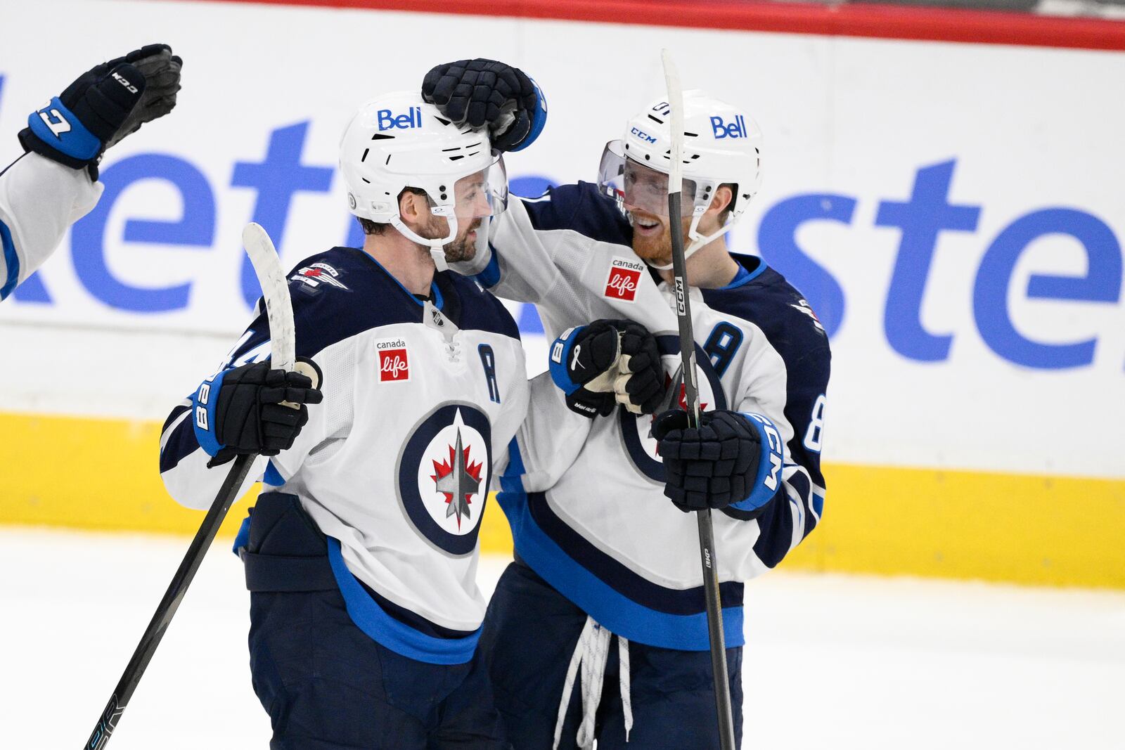 Winnipeg Jets defenseman Josh Morrissey, left, celebrates his game-winning goal with left wing Kyle Connor, right, during overtime of an NHL hockey game against the Washington Capitals, Saturday, Feb. 1, 2025, in Washington. (AP Photo/Nick Wass)