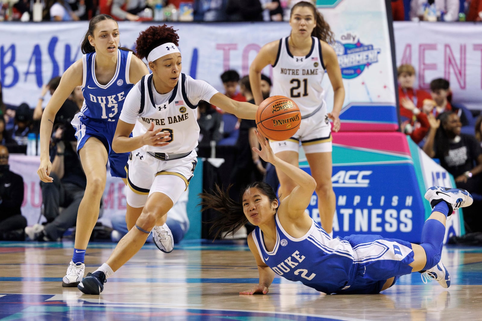 Notre Dame's Hannah Hidalgo (3) gathers a loose ball ahead of Duke's Vanessa de Jesus (2) and Jordan Wood (13) during the first half of an NCAA college basketball game in the semifinals of the Atlantic Coast Conference tournament in Greensboro, N.C., Saturday, March 8, 2025. (AP Photo/Ben McKeown)