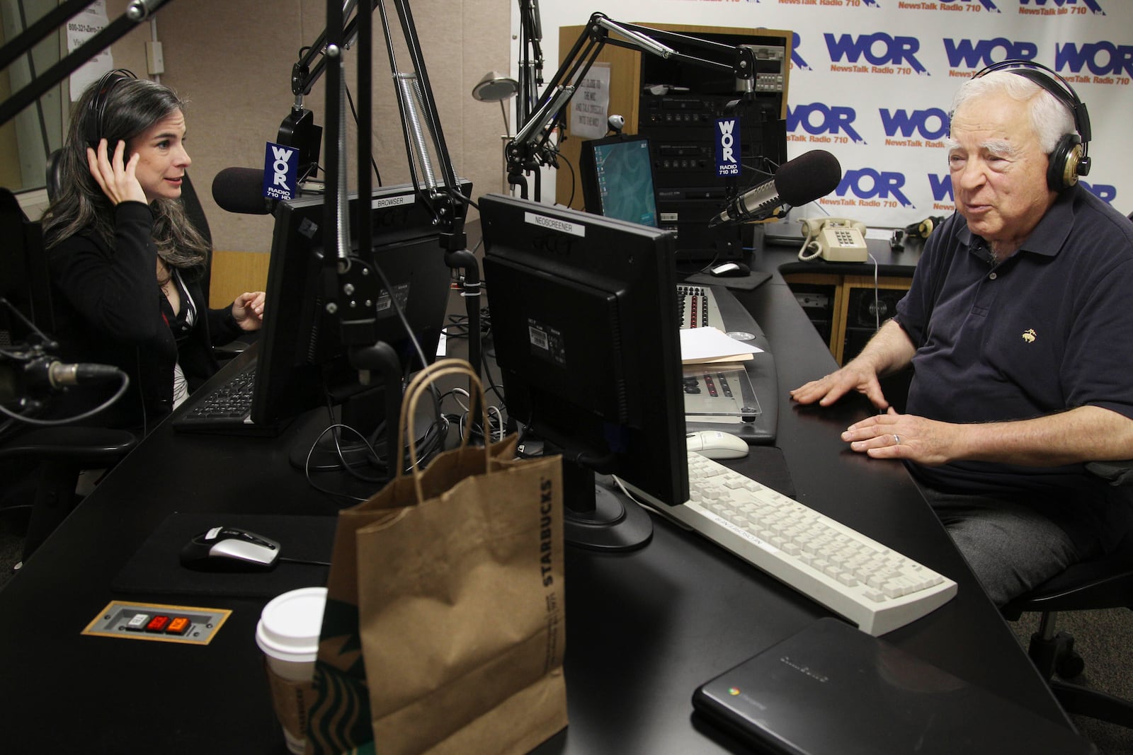 FILE - Arthur Frommer, 83, and his daughter, Pauline Frommer, 46, prepare for their radio show at the WOR studios in New York, May 20, 2012. (AP Photo/Seth Wenig, File)