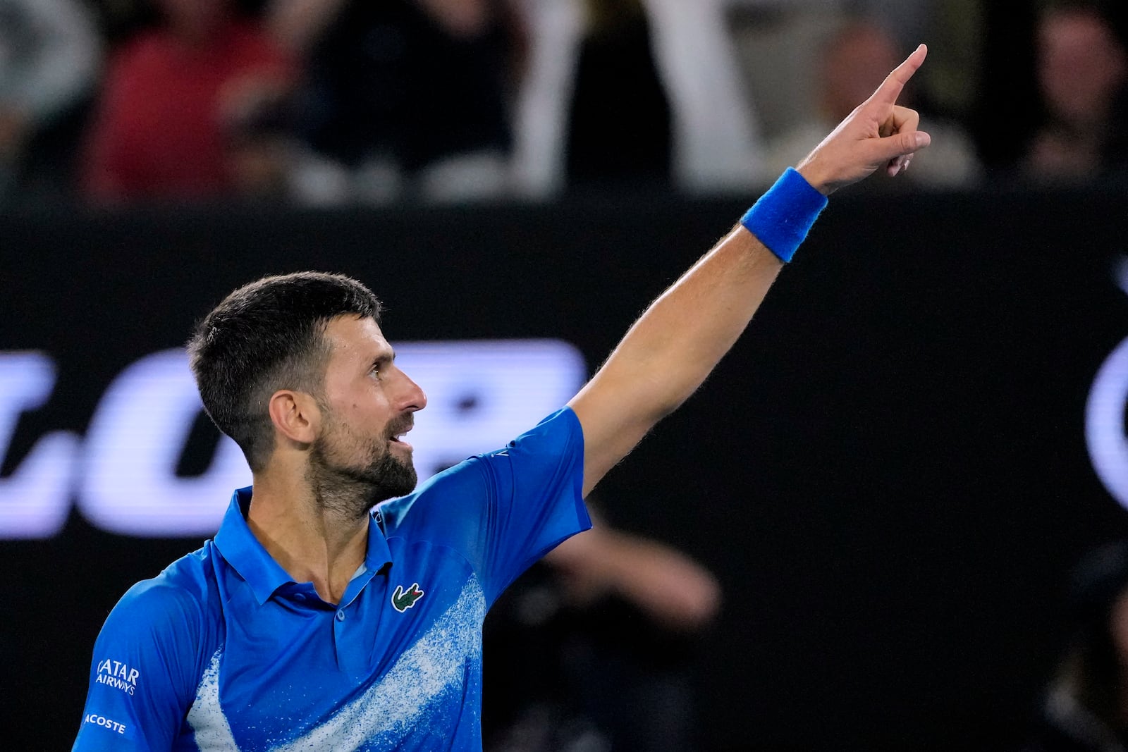 Novak Djokovic of Serbia gestures during his quarterfinal match against Carlos Alcaraz of Spain at the Australian Open tennis championship in Melbourne, Australia, Tuesday, Jan. 21, 2025. (AP Photo/Vincent Thian)