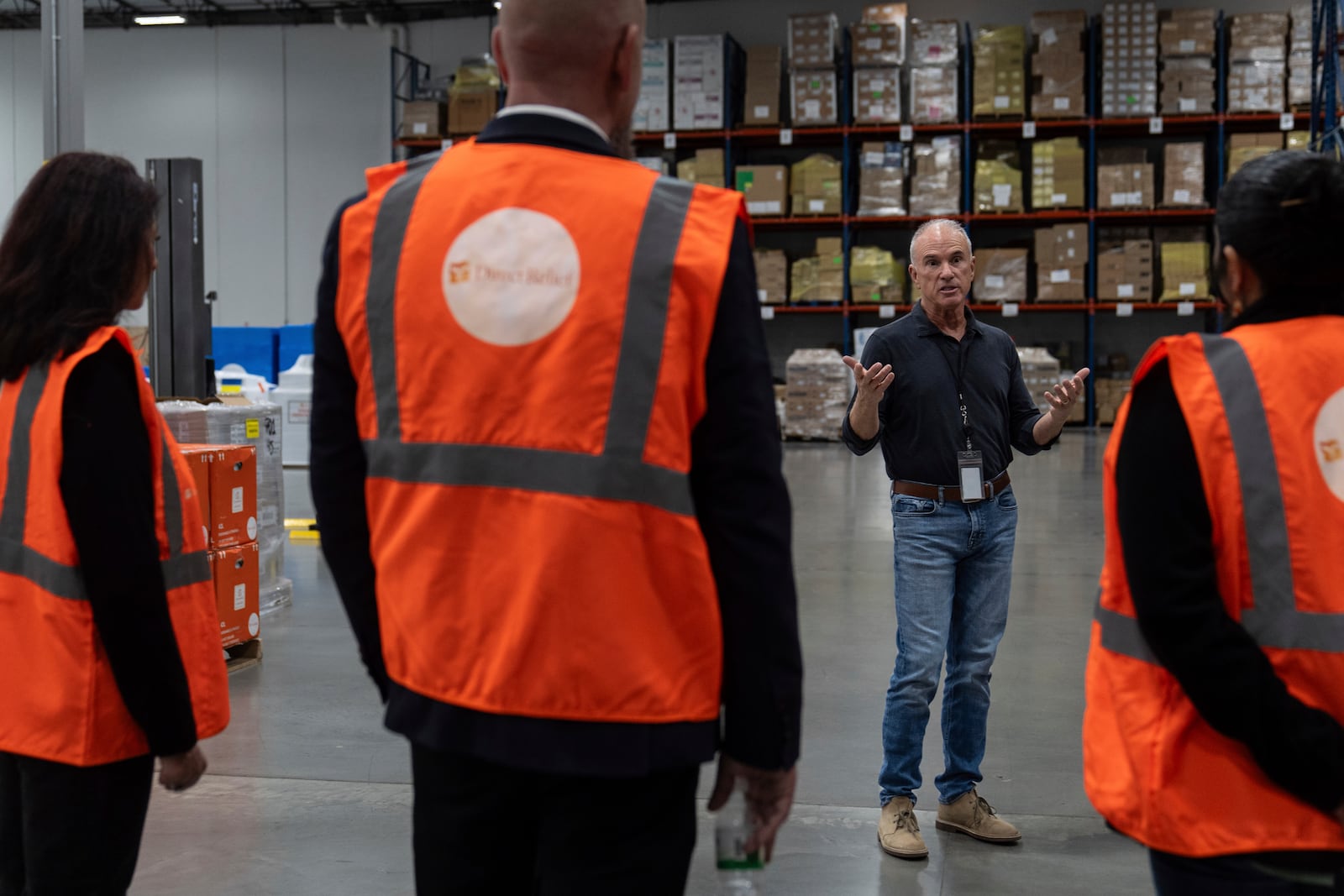 Thomas Tighe, president and CEO of Direct Relief, talks to visitors at its headquarters in Santa Barbara, Calif., Friday, Dec. 20, 2024. (AP Photo/Jae C. Hong)