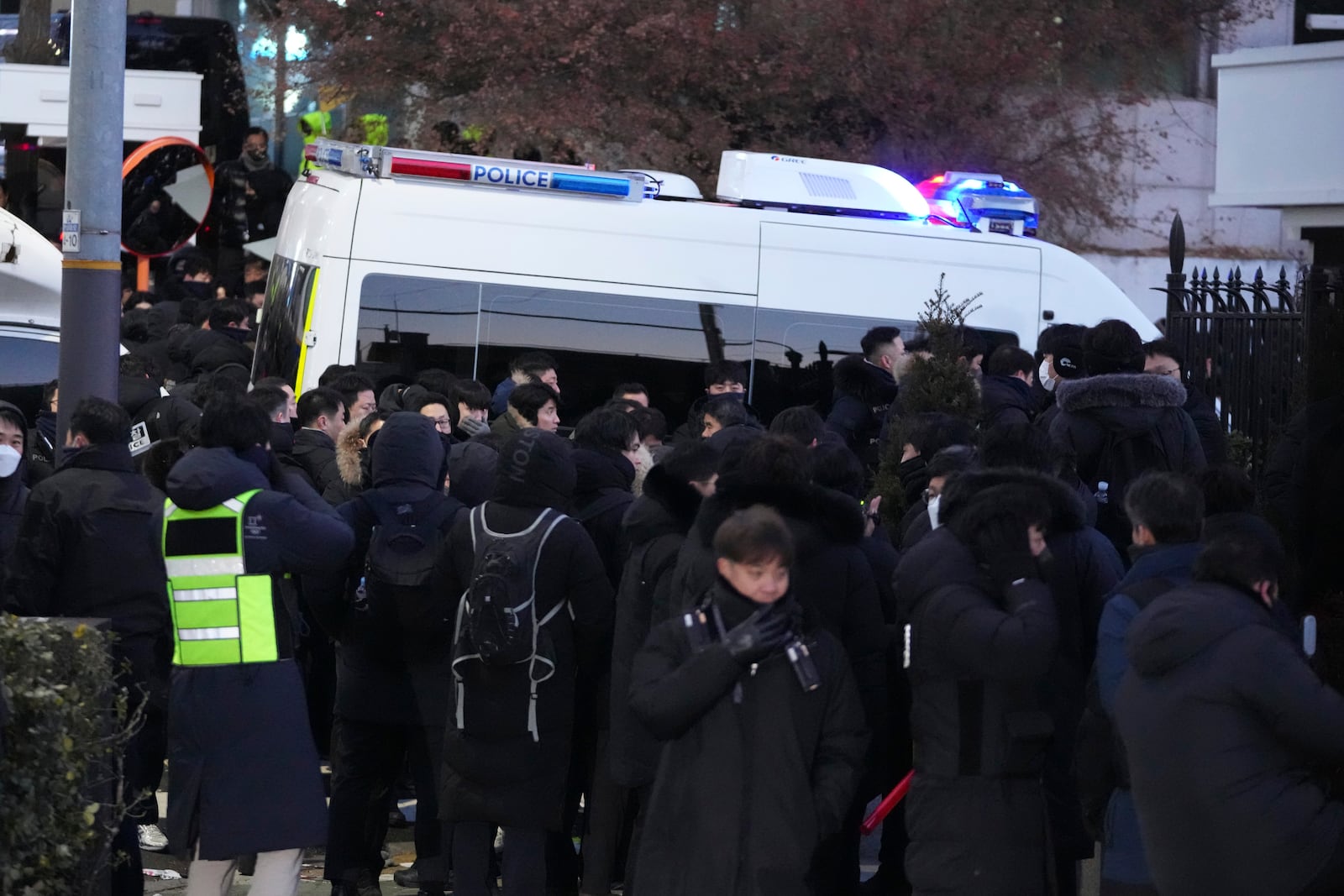 Police officers gather outside of the gate of the presidential residence in Seoul, South Korea, Wednesday, Jan. 15, 2025. (AP Photo/Lee Jin-man)