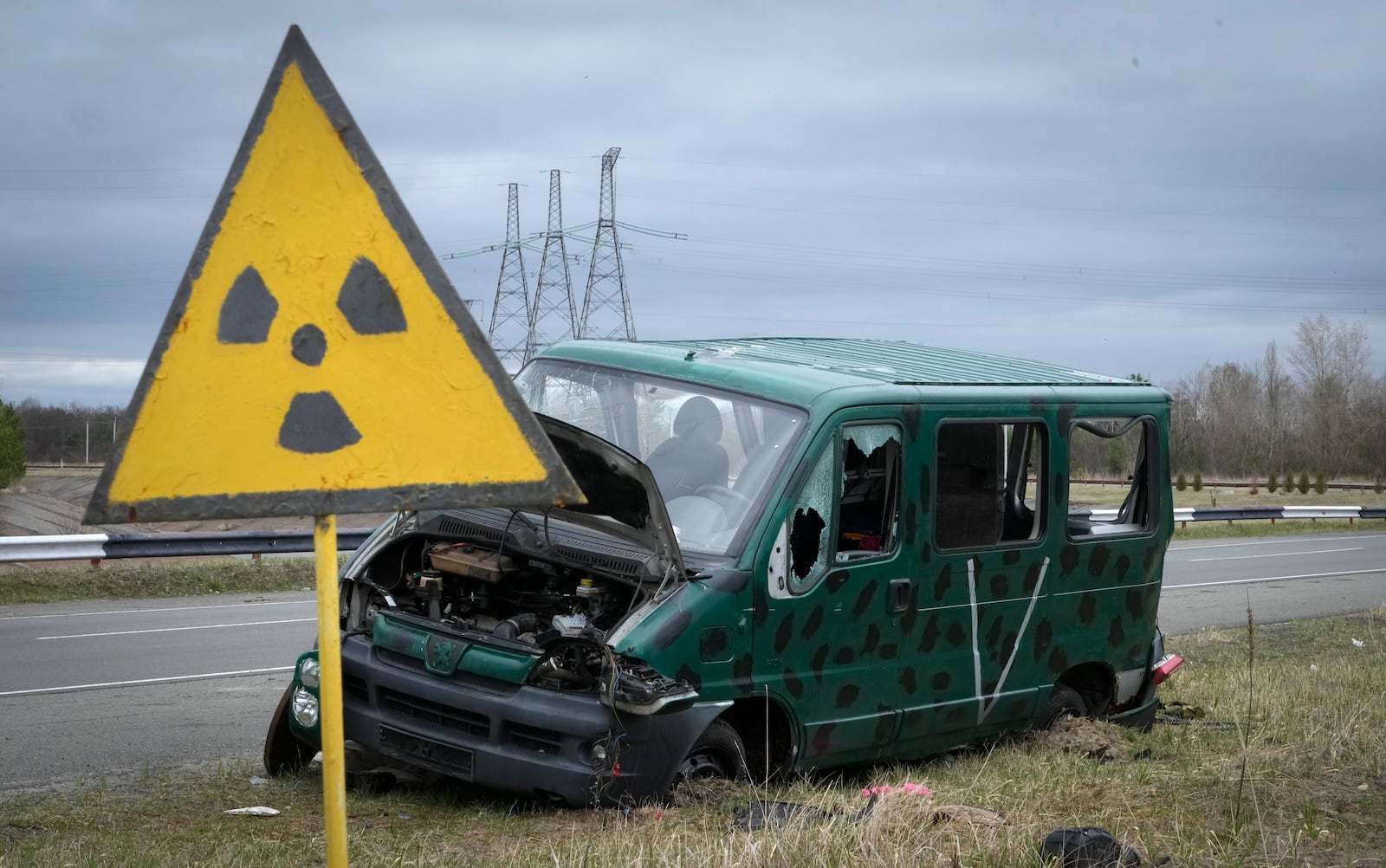 FILE - A radiation sign is seen near a broken Russian vehicle with a V letter, a sign of the Russian army, close to the Chernobyl nuclear power plant in Chernobyl, Ukraine, April 16, 2022. (AP Photo/Efrem Lukatsky, File)