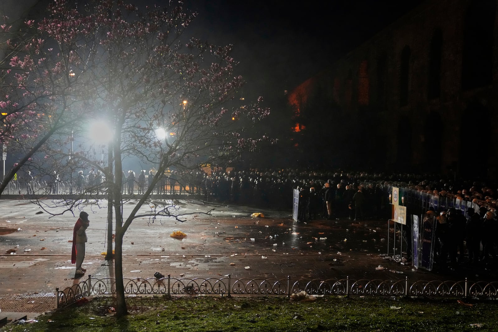 A man stands in front of anti riot police officers during clashes in a rally against the arrest of Istanbul's Mayor Ekrem Imamoglu, in Istanbul, Turkey, Friday, March 21, 2025. (AP Photo/Khalil Hamra)