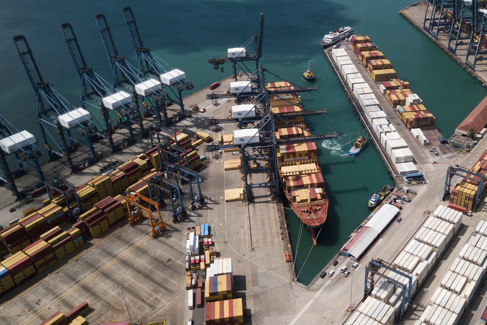 Cranes load and unload containers from cargo ships at the Cristobal port, operated by the Panama Ports Company, in Colon, Panama, Tuesday, Feb. 4, 2025. (AP Photo/Matias Delacroix)