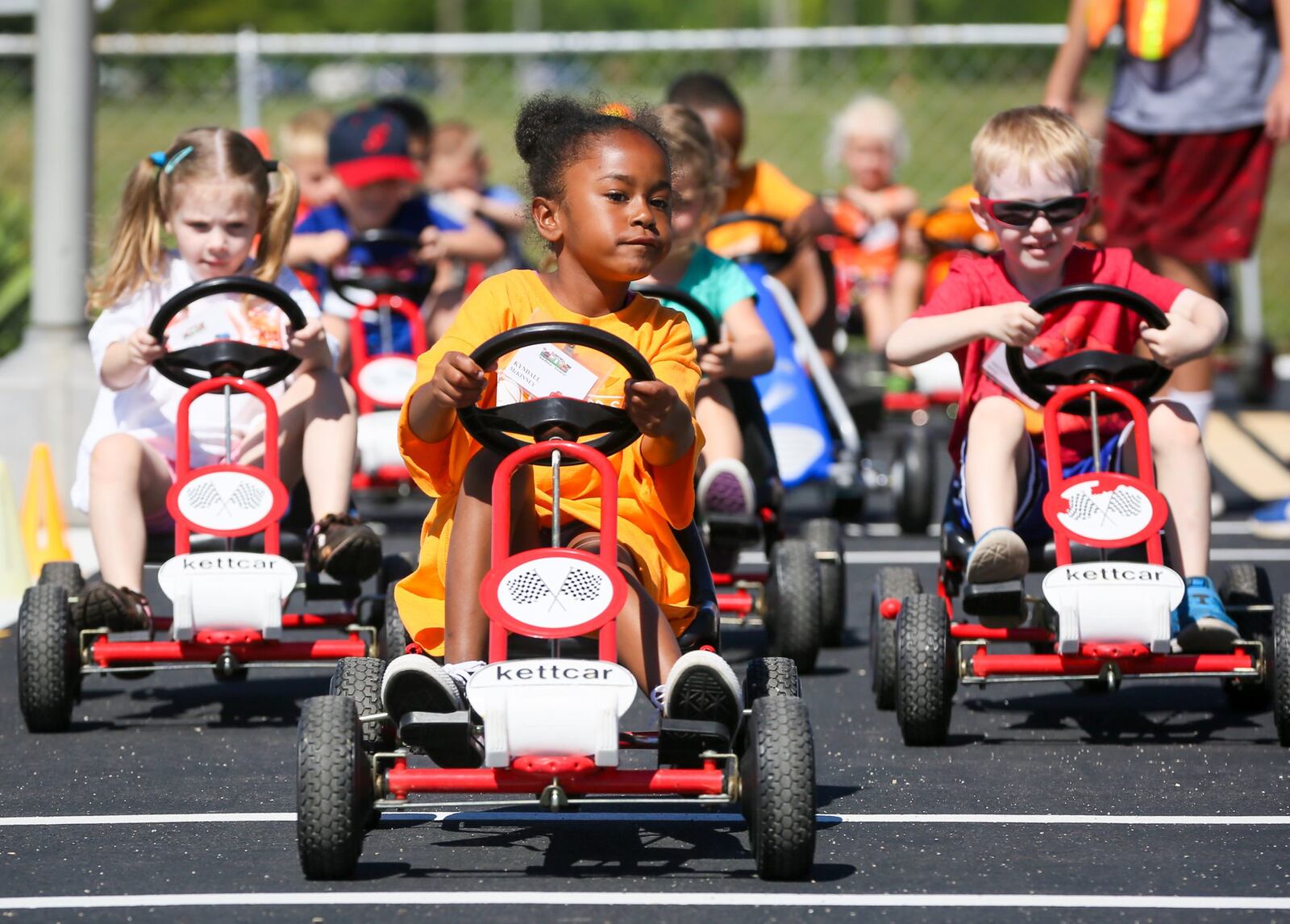 This photo is from 2017: Kyndall Mckinney leads a group in their toy cars as they learn about road rules during Safety Town this week at Officer Bob Gentry Park in Hamilton. GREG LYNCH / STAFF