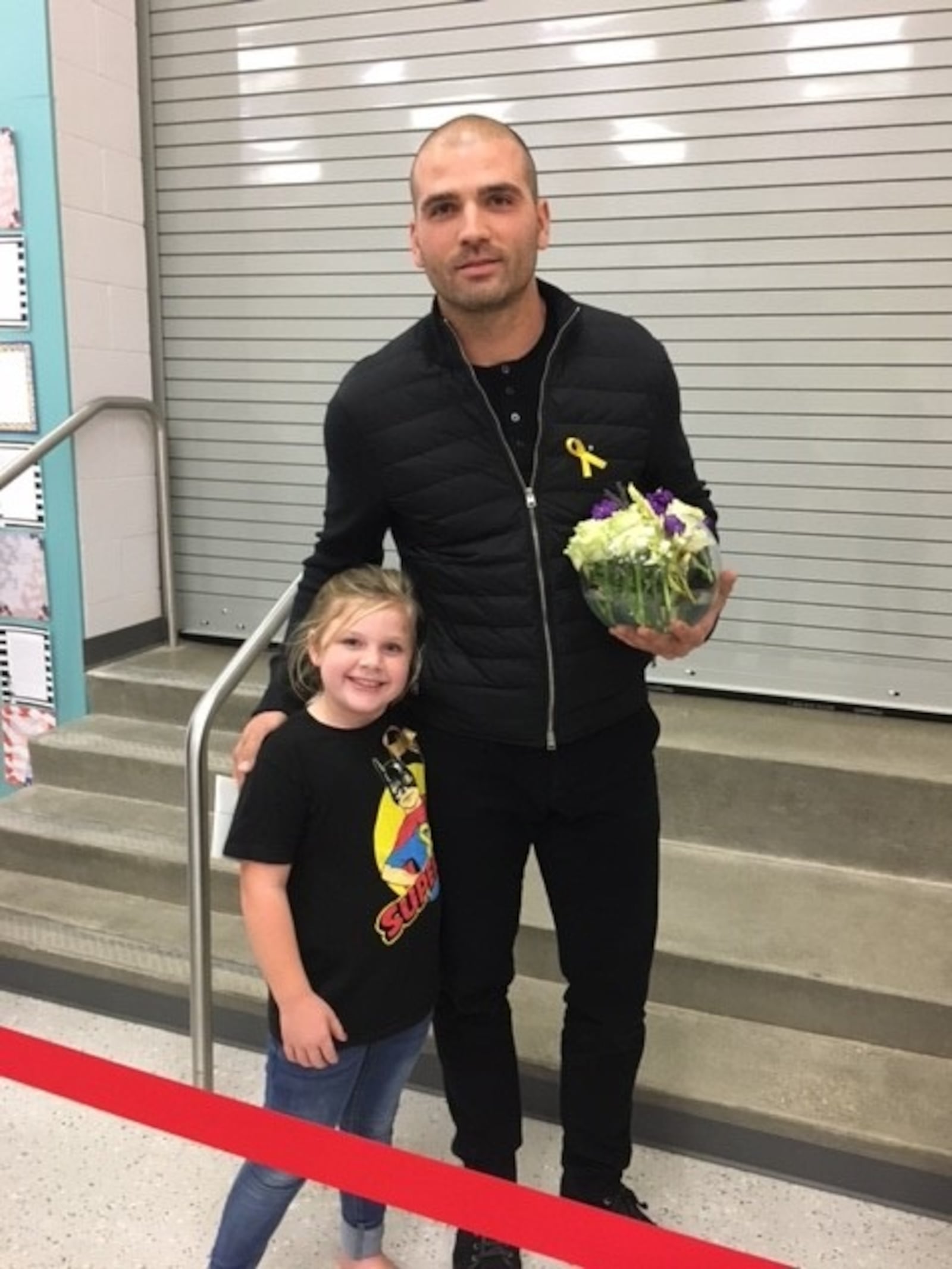 Cincinnati Reds first baseman Joey Votto poses with Walter “Superbubz” Herbert’s sister Adley at Walter’s visitation Thursday at Fairfield’s Central Elementary. Votto befriended Walter in the last weeks of his young life. 