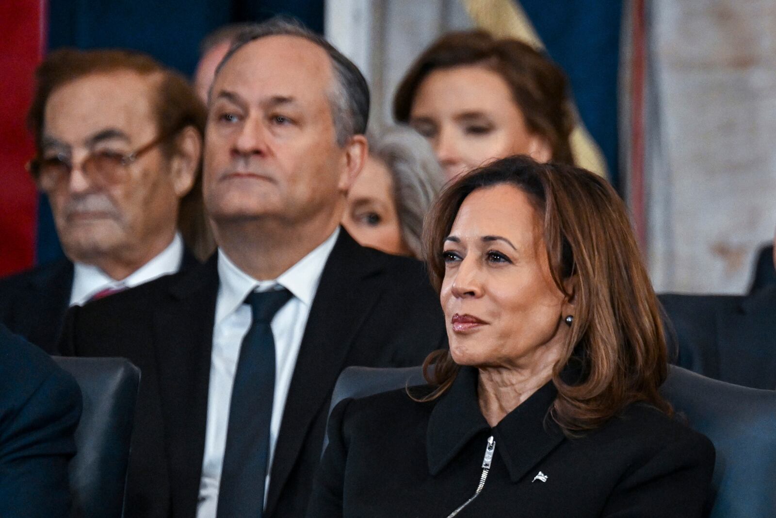 Former Vice President Kamala Harris, right, and Doug Emhoff listen listen as President Donald Trump speaks after taking the oath of office at the 60th Presidential Inauguration in the Rotunda of the U.S. Capitol in Washington, Monday, Jan. 20, 2025. (Kenny Holston/The New York Times via AP, Pool)