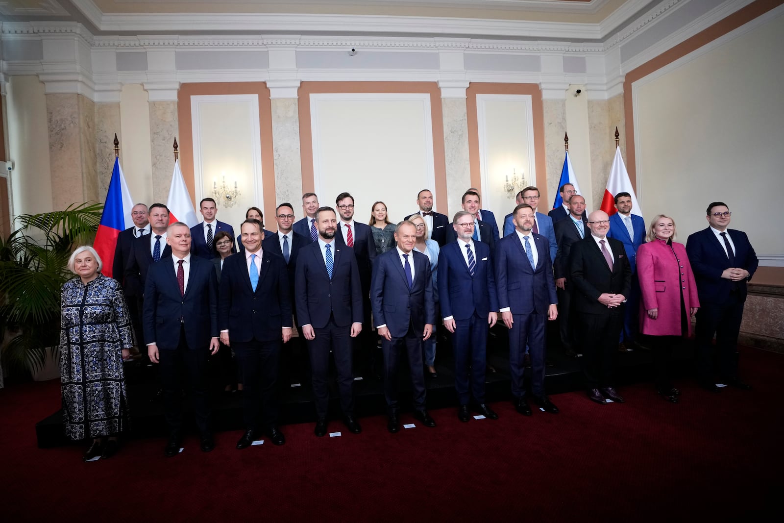 Czech Republic's Prime Minister Petr Fiala, center right, welcomes his Poland's counterpart Donald Tusk, center left, and his ministers as their governments meet in Prague, Czech Republic, Wednesday, Oct. 9, 2024. (AP Photo/Petr David Josek)