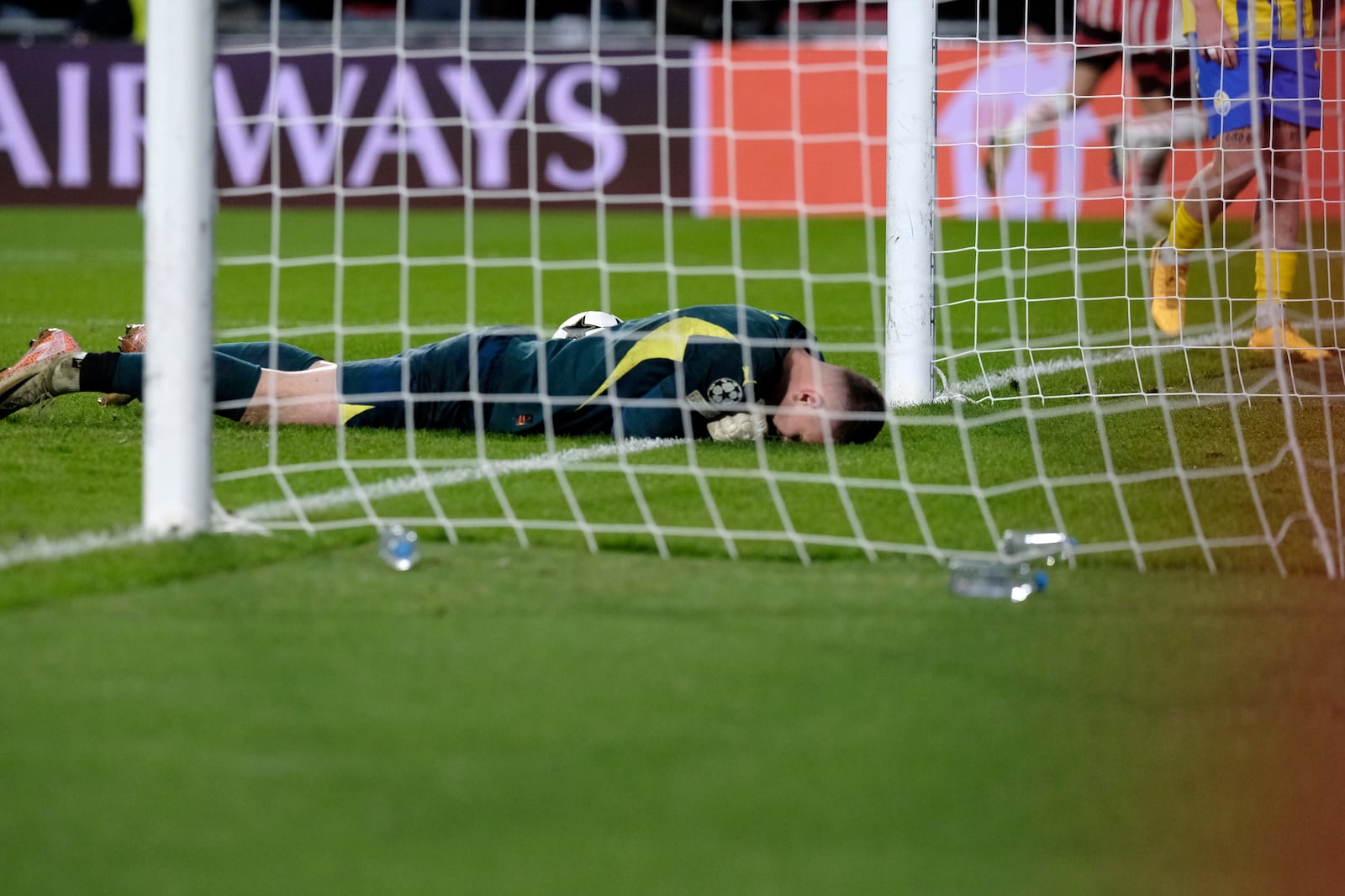 Shakhtar's goalkeeper Dmytro Riznyk lays in the goal after PSV's Ricardo Pepi scored his sides third goal during the Champions League opening phase soccer match between PSV Eindhoven and Shakhtar Donetsk at the PSV Stadium in Eindhoven, Netherlands, Wednesday, Nov. 27, 2024. (AP Photo/Patrick Post)