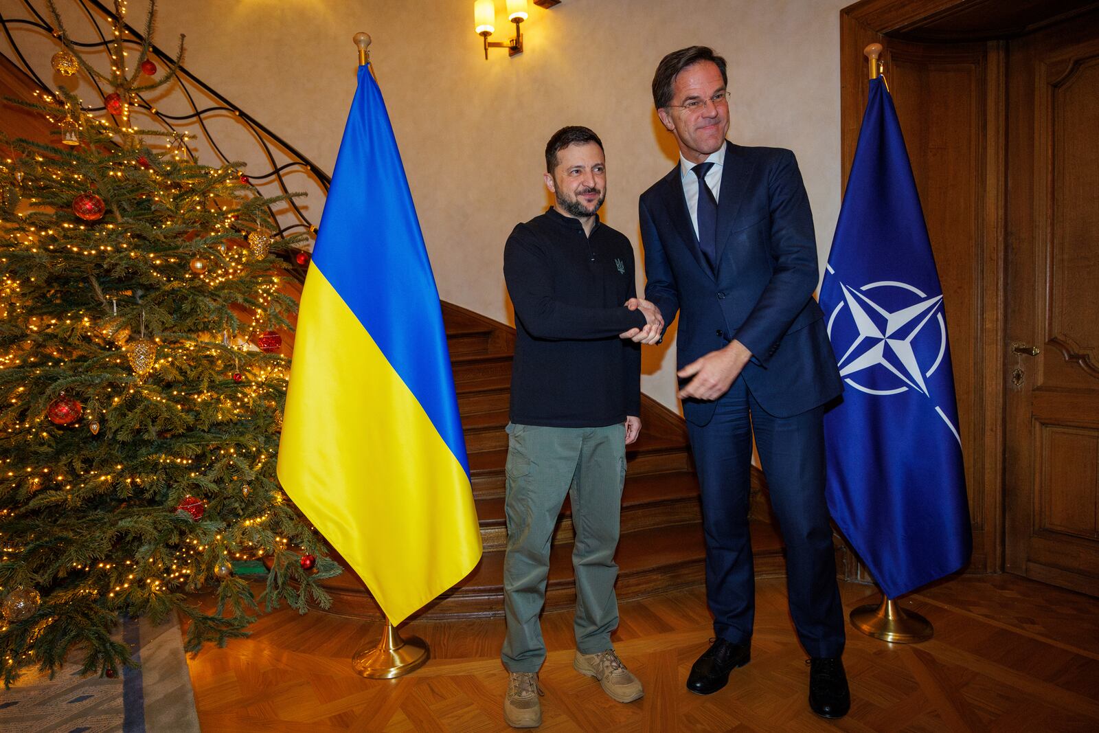 FILE -NATO Secretary General Mark Rutte, right, shakes hands with Ukraine's President Volodymyr Zelenskyy prior to a meeting in Brussels on Wednesday, Dec. 18, 2024. (Olivier Matthys, Pool Photo via AP, File)