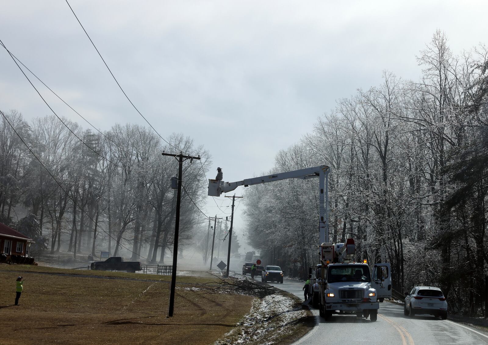 Utility crews work on power lines after a winter storm blanketed the area Thursday, Feb. 13, 2025, in Franklin County, Va. (Heather Rousseau/The Roanoke Times via AP)