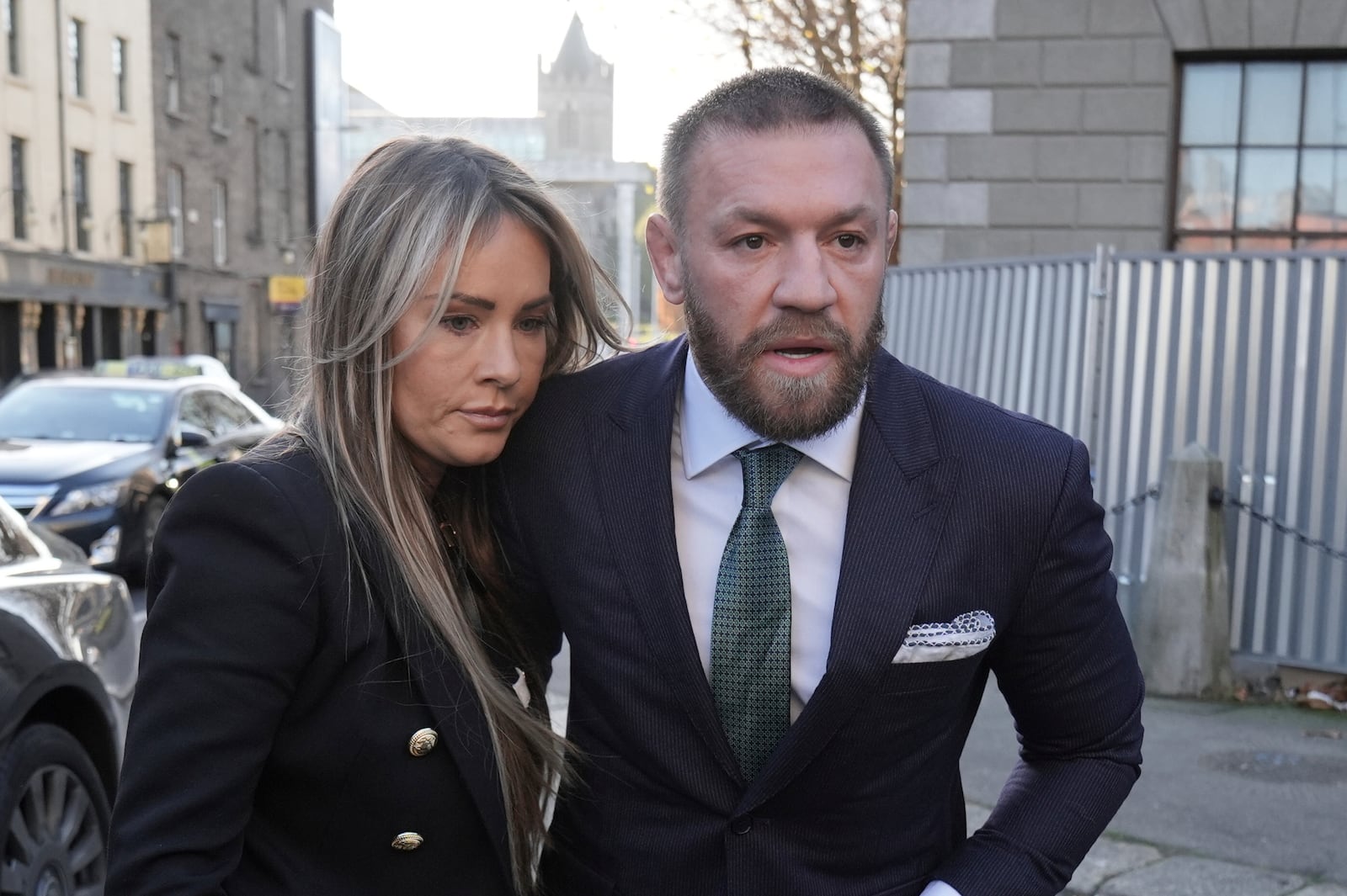 Mixed martial arts fighter Conor McGregor and partner Dee Devlin walk outside the High Court in Dublin, where he is appearing for a personal injury case against him, on Friday Nov. 22, 2024. (Brian Lawless/PA via AP)