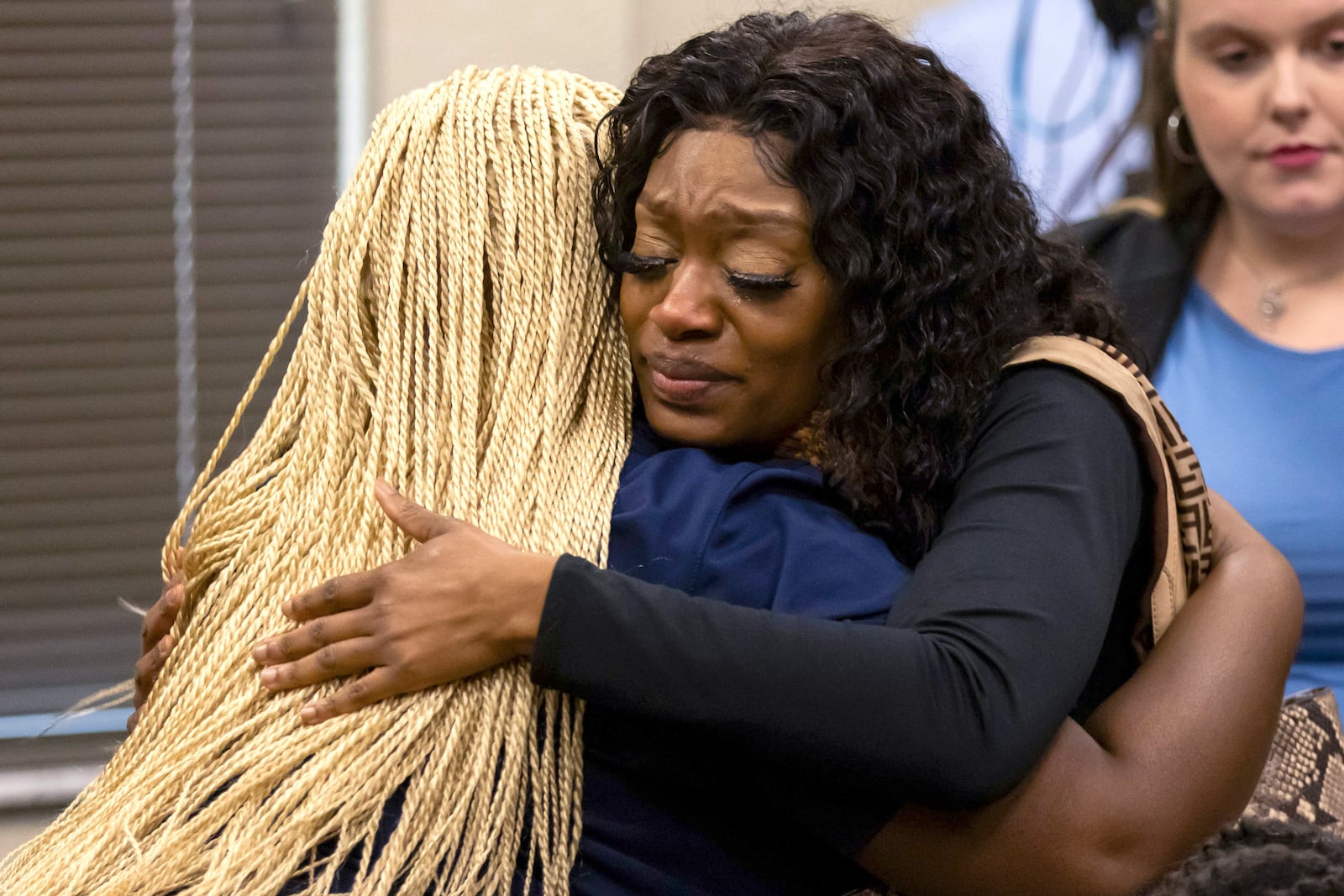 Velicia Woodyard, right, a close friend of shooting victim Ajike "AJ" Owens, hugs a friend during the sentencing hearing for defendant Susan Lorincz, Monday, Nov. 25, 2024, in Ocala, Fla. (Doug Engle/Ocala Star-Banner via AP, Pool)