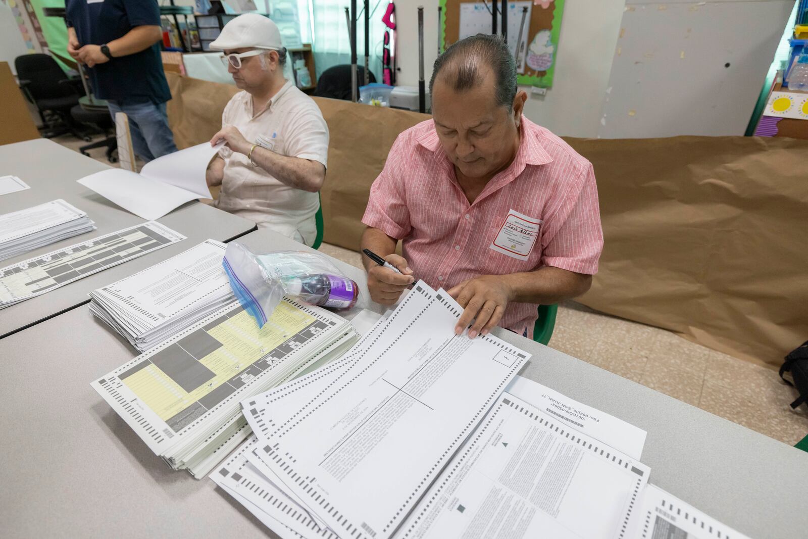 An election official sorts ballots during the general elections in San Juan, Puerto Rico, Tuesday, Nov. 5, 2024. (AP Photo/Alejandro Granadillo)