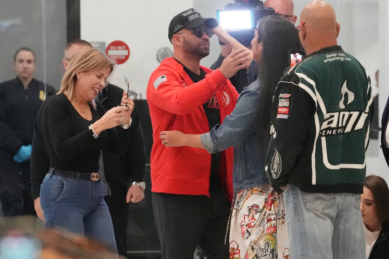 Enrique Tarrio hugs supporters after arriving at Miami International Airport, Wednesday, Jan. 22, 2025, in Miami. Tarrio was pardoned by President Donald Trump after he was convicted of seditious conspiracy for his role in the January 6 attack on the U.S. Capitol. (AP Photo/Marta Lavandier)