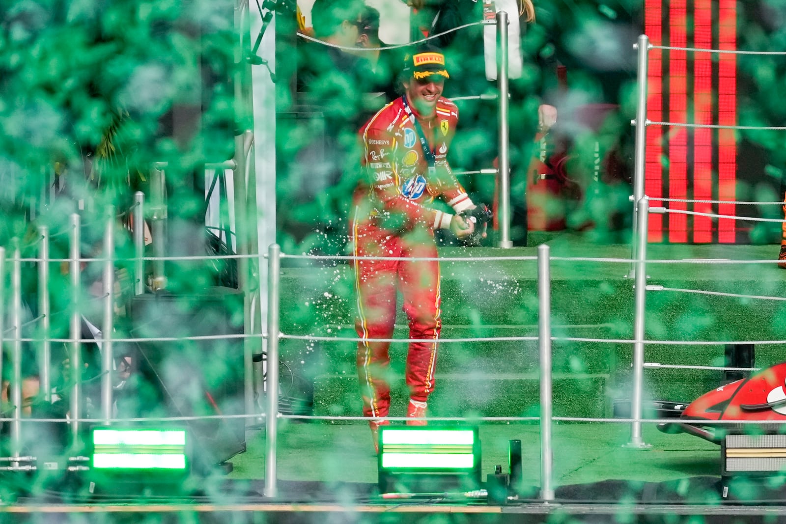 Ferrari driver Carlos Sainz of Spain, center, celebrates after winning the Formula One Mexico Grand Prix auto race at the Hermanos Rodriguez racetrack in Mexico City, Sunday, Oct. 27, 2024. (AP Photo/Eduardo Verdugo)