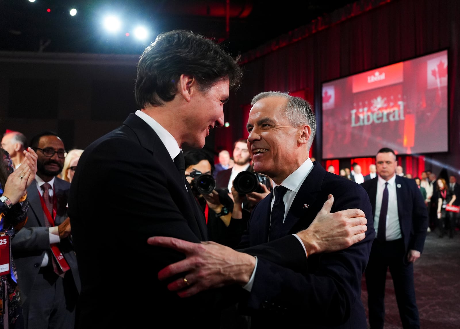 Liberal Party of Canada Leader Mark Carney, right, speaks to Canadian Prime Minister Justin Trudeau after Carney was announced as the winner of the party leadership at the announcement event in Ottawa, Ontario, Sunday, March 9, 2025. (Sean Kilpatrick/The Canadian Press via AP)