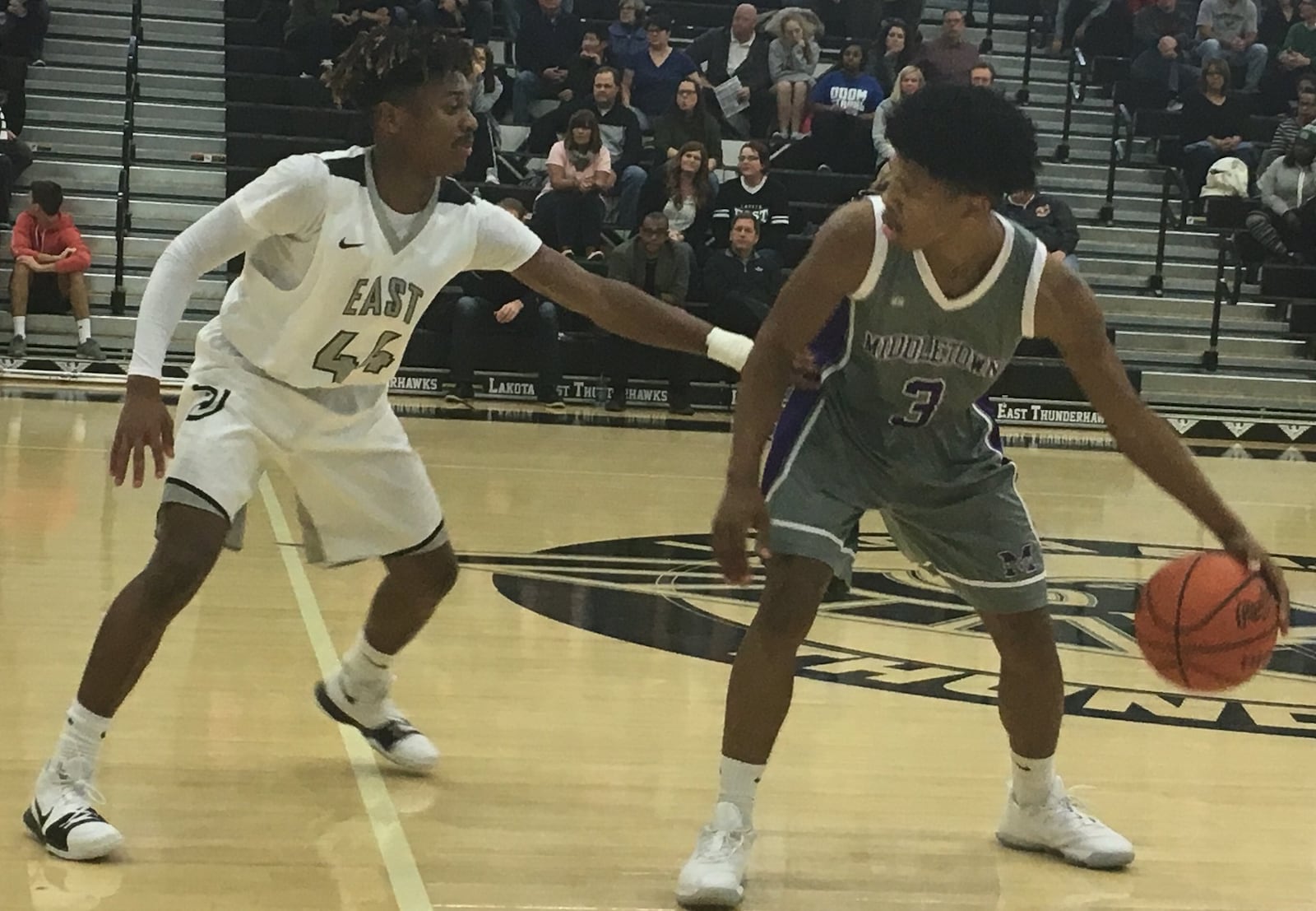 Lakota East’s Jalen Peck (44) defends KeiAunte Powell of Middletown on Tuesday night at East. RICK CASSANO/STAFF