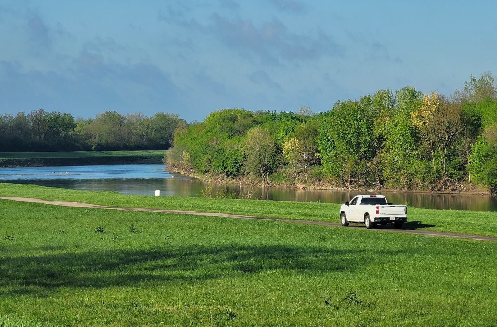 A Miami Conservancy District vehicle travels on the bike path along the Great Miami River in Middletown. NICK GRAHAM/STAFF