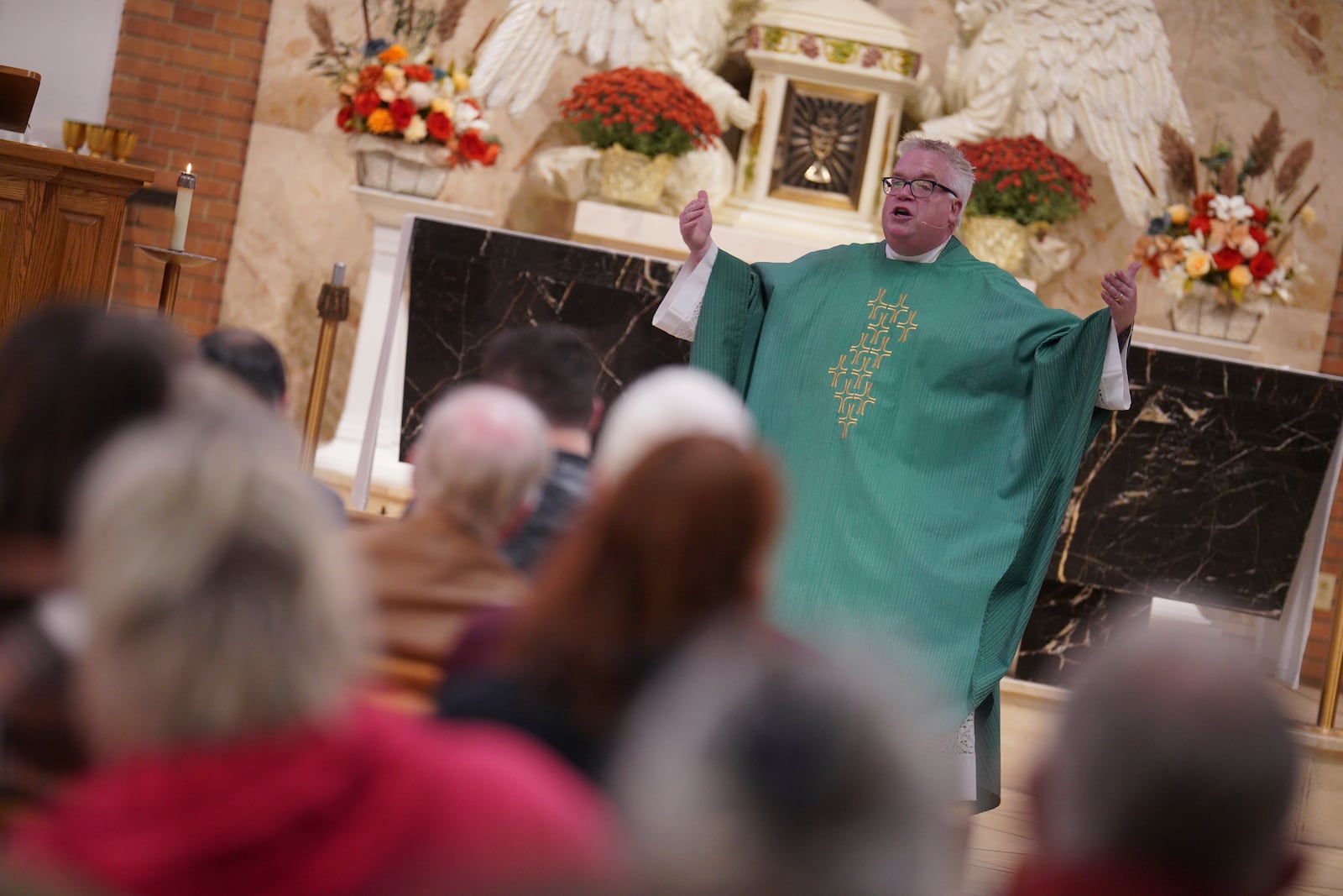 The Rev. Tim Biren leads the English-language Mass at St. Mary’s Catholic Church on Saturday, Oct. 19, 2024, in Worthington, Minn. (AP Photo/Jessie Wardarski)