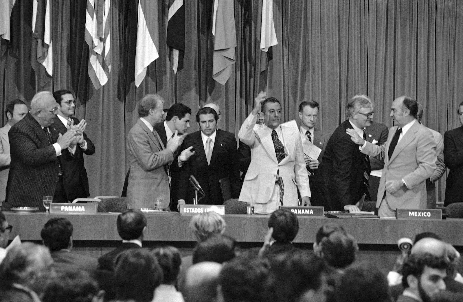 FILE - President Jimmy Carter applauds and General Omar Torrijos waves after the signing and exchange of treaties in Panama City on June 16, 1978, giving control of the Panama Canal to Panama in 2000. At far right is Zbigniew Brzezinski, Carterís National Security Advisor. (AP Photo, File)