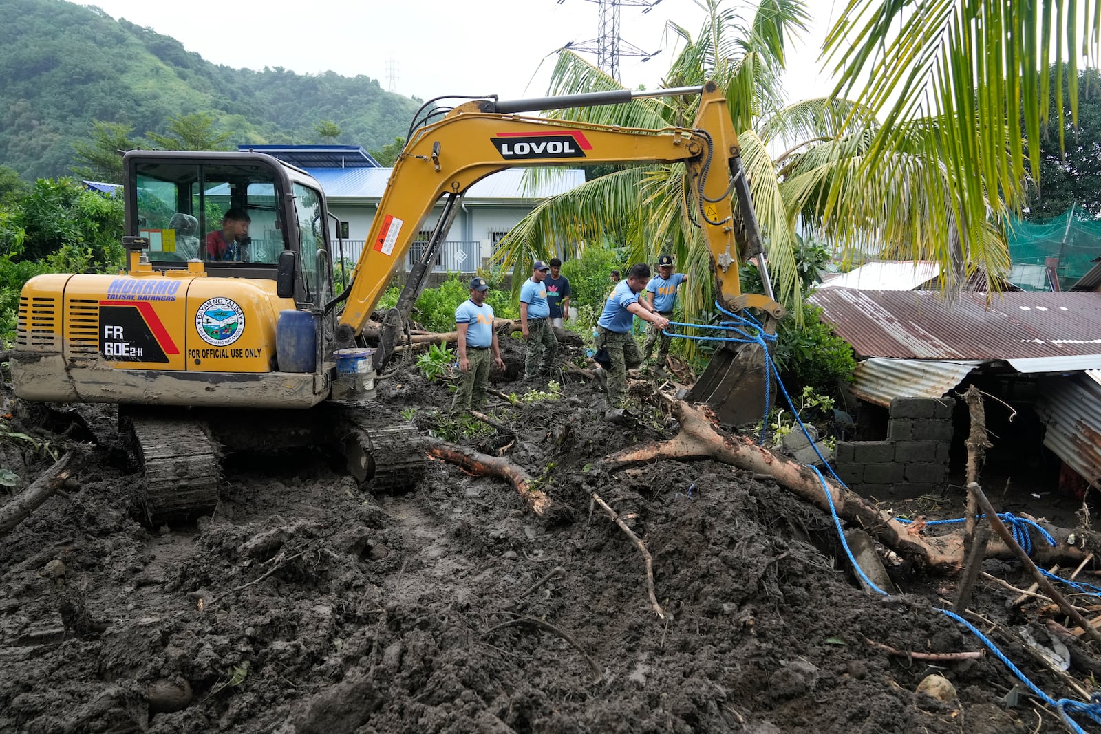 Rescuers work at the site after a recent landslide triggered by Tropical Storm Trami struck Talisay, Batangas province, Philippines leaving thousands homeless and several villagers dead on Saturday, Oct. 26, 2024. (AP Photo/Aaron Favila)