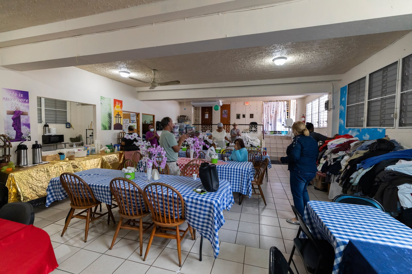 Pastor Nilka Marrero, right, and other San Pablo Methodist Church volunteers organize donations for the immigrant community in Barrio Obrero, San Juan, Puerto Rico, Friday, March 14, 2025. (AP Photo/Alejandro Granadillo)