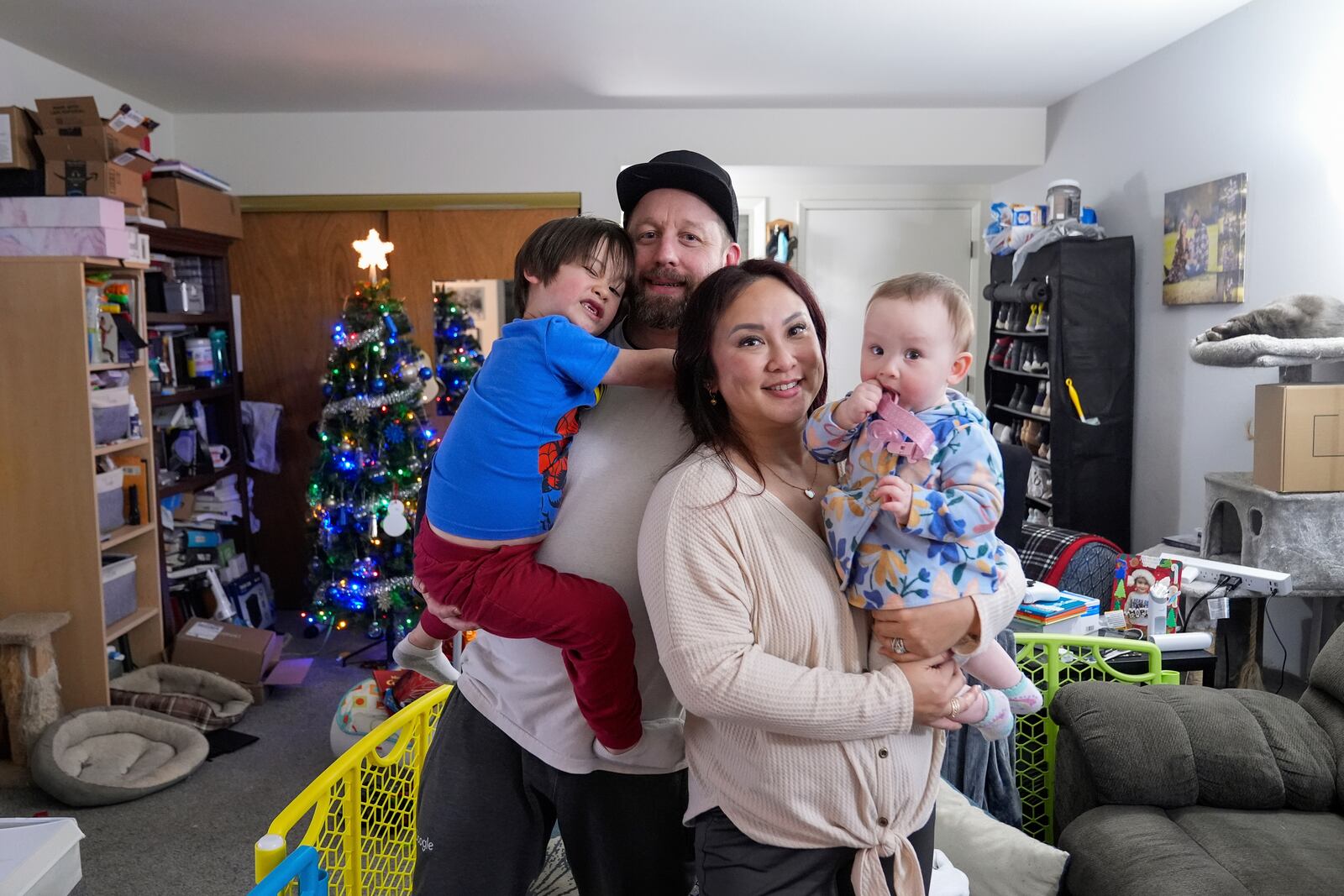 Steve Petersen, second from left, his wife Jennifer and their children Jerrik, left, and Carolynn, are photographed at their apartment in Campbell, Calif., Wednesday, Jan. 15, 2025. (AP Photo/Godofredo A. Vásquez)