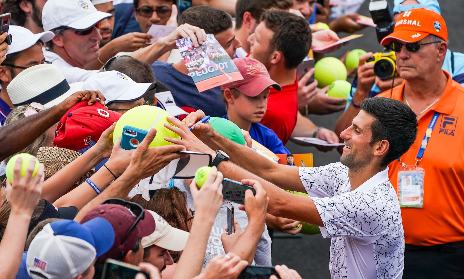 Novak Djokovic signs autographs during the Western & Southern Open tennis tournament at Lindner Family Tennis Center Wednesday, Aug. 15 in Mason. NICK GRAHAM/STAFF