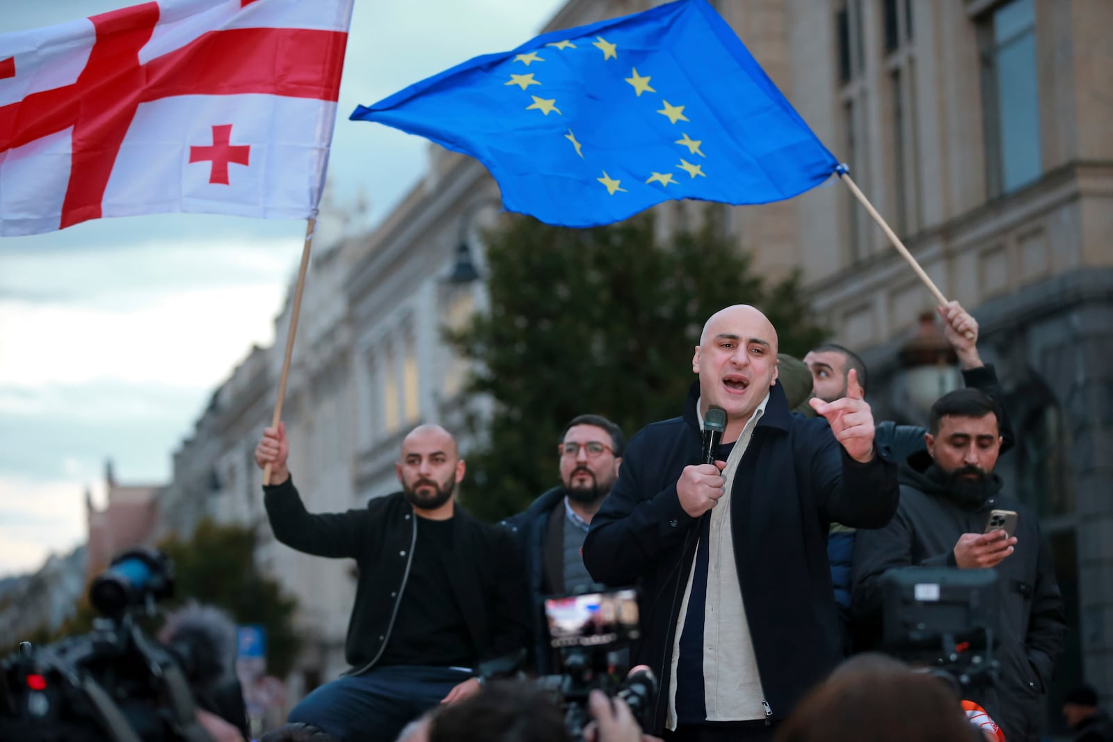 leader of Strong Georgia Coallition Nika Gvaramia, foreground right, gestures speaking to the crowd take during a rally against alleged violations in a recent parliamentary election in Tbilisi, Georgia, Monday, Nov. 4, 2024. (AP Photo/Zurab Tsertsvadze)