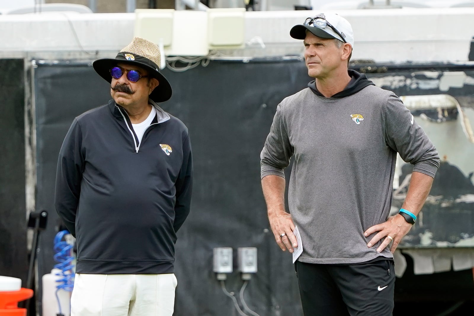 FILE - Jacksonville Jaguars owner Shad Khan, left, and general manager Trent Baalke watch players during the NFL football team's rookie minicamp, Saturday, May 14, 2022, in Jacksonville, Fla. (AP Photo/John Raoux, File)