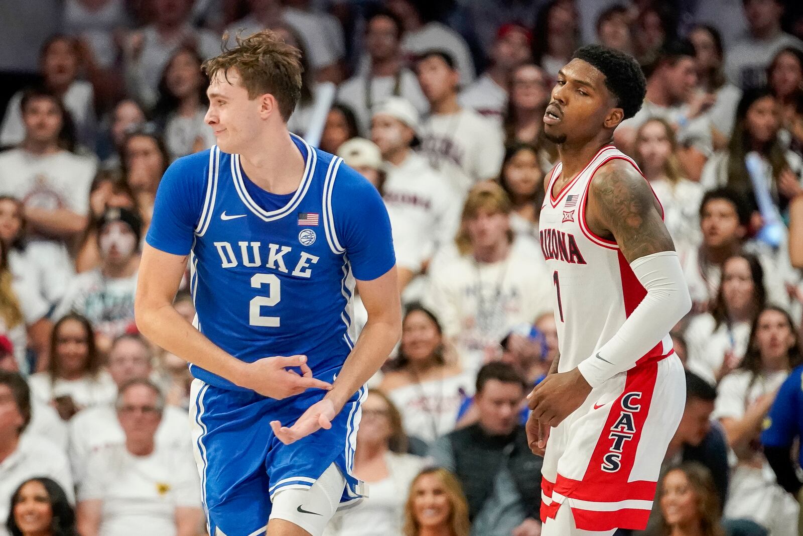 Duke guard Cooper Flagg (2) gestures after scoring against Arizona guard Caleb Love (1) during the second half of an NCAA college basketball game Friday, Nov. 22, 2024, in Tucson, Ariz. (AP Photo/Darryl Webb)