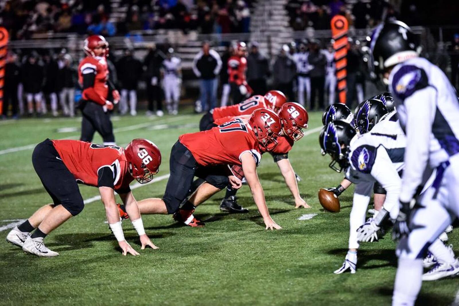 Madison’s Cole Pelgen (36), Tanner Limon (37), Max Evans (38) and Levi McMonigle (30) prepare to attack the Cincinnati Hills Christian Academy offense during last Friday night’s 35-27 Division V playoff win at Lakota East. NICK GRAHAM/STAFF