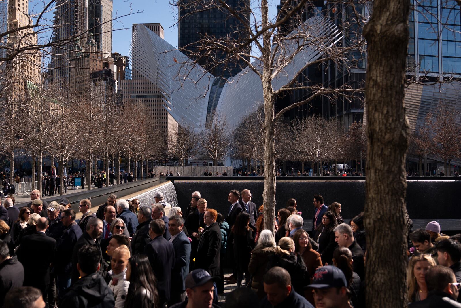 Mourners gather before a ceremony marking the anniversary of the 1993 World Trade Center bombing at the 9/11 Memorial, Wednesday, Feb. 26, 2025, in New York. (AP Photo/John Minchillo)