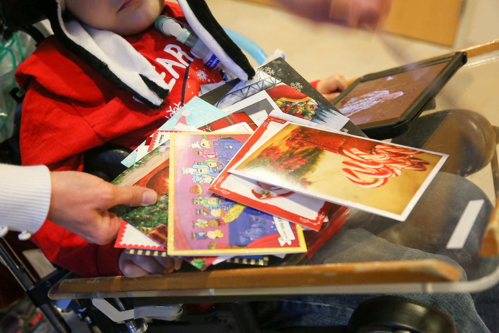 All Andrew Little, 8, wants for Christmas is enough holiday cards to cover the walls of his room at St. Joseph Home in Sharonville, and share them with his friends at the facility for wheelchair-bound people with complex medical needs. GREG LYNCH / STAFF