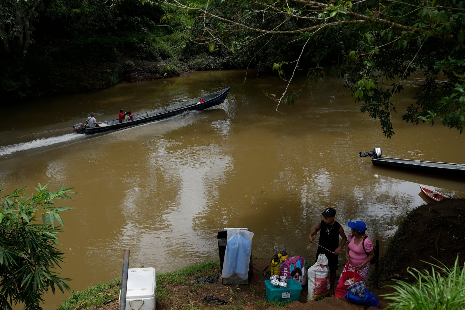 Locals commute along the Indio River near El Jobo village, Panama, Saturday, Aug. 31, 2024. El Jobo could lose reliable access to water under a proposed plan to dam the river to secure the Panama Canal’s uninterrupted operation. (AP Photo/Matias Delacroix)