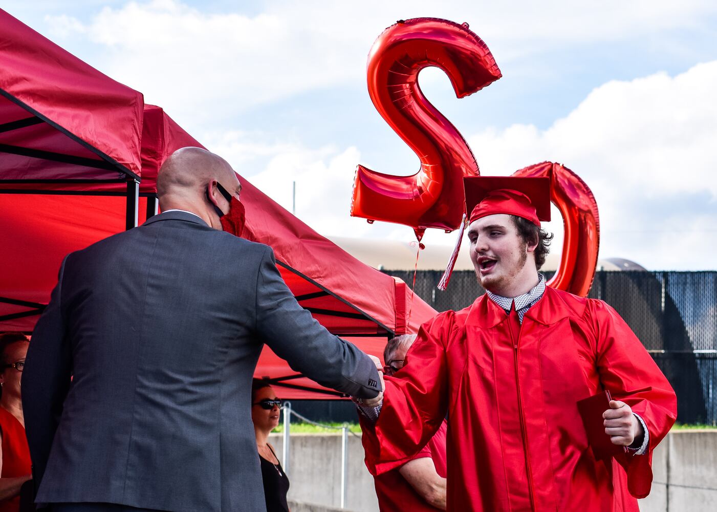 Madison High School drive-thru graduation ceremony at Land of Illusion