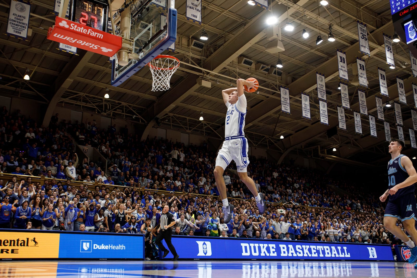 Duke's Cooper Flagg (2) dunks on a fast break during the second half of an NCAA college basketball game against Maine in Durham, N.C., Monday, Nov. 4, 2024. (AP Photo/Ben McKeown)