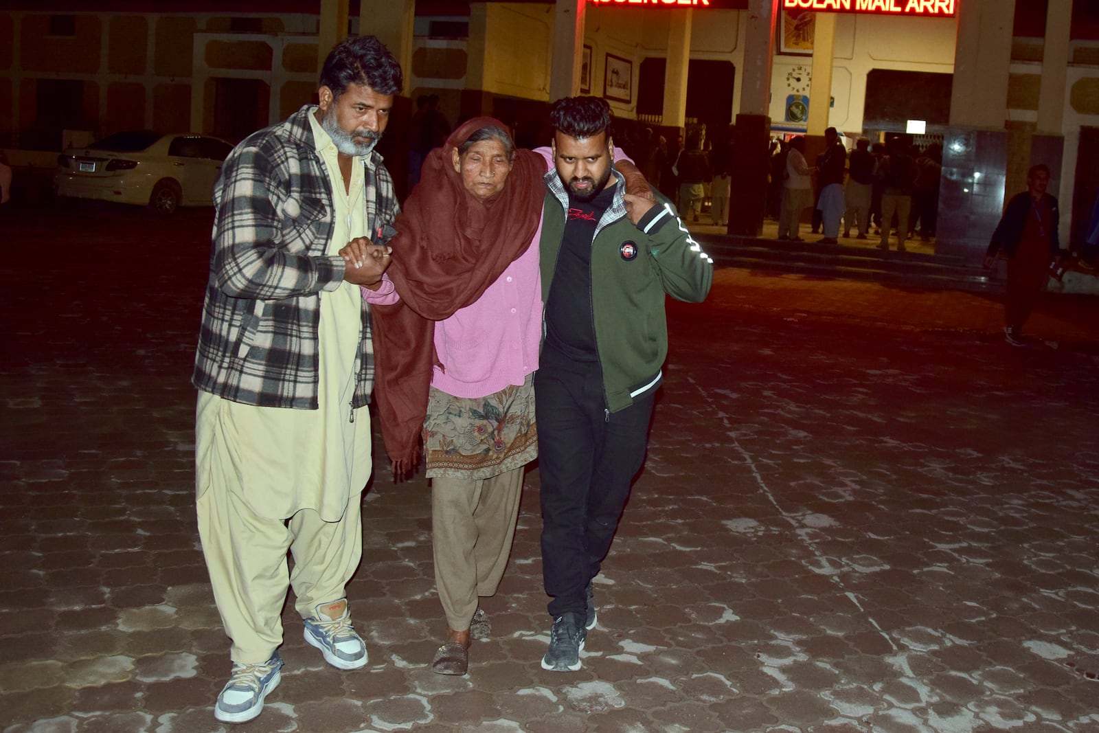 Passengers rescued by security forces from a passenger train attacked by insurgents arrive at a railway station in Quetta, Pakistan, Wednesday, March 12, 2025. (AP Photo/Arshad Butt)