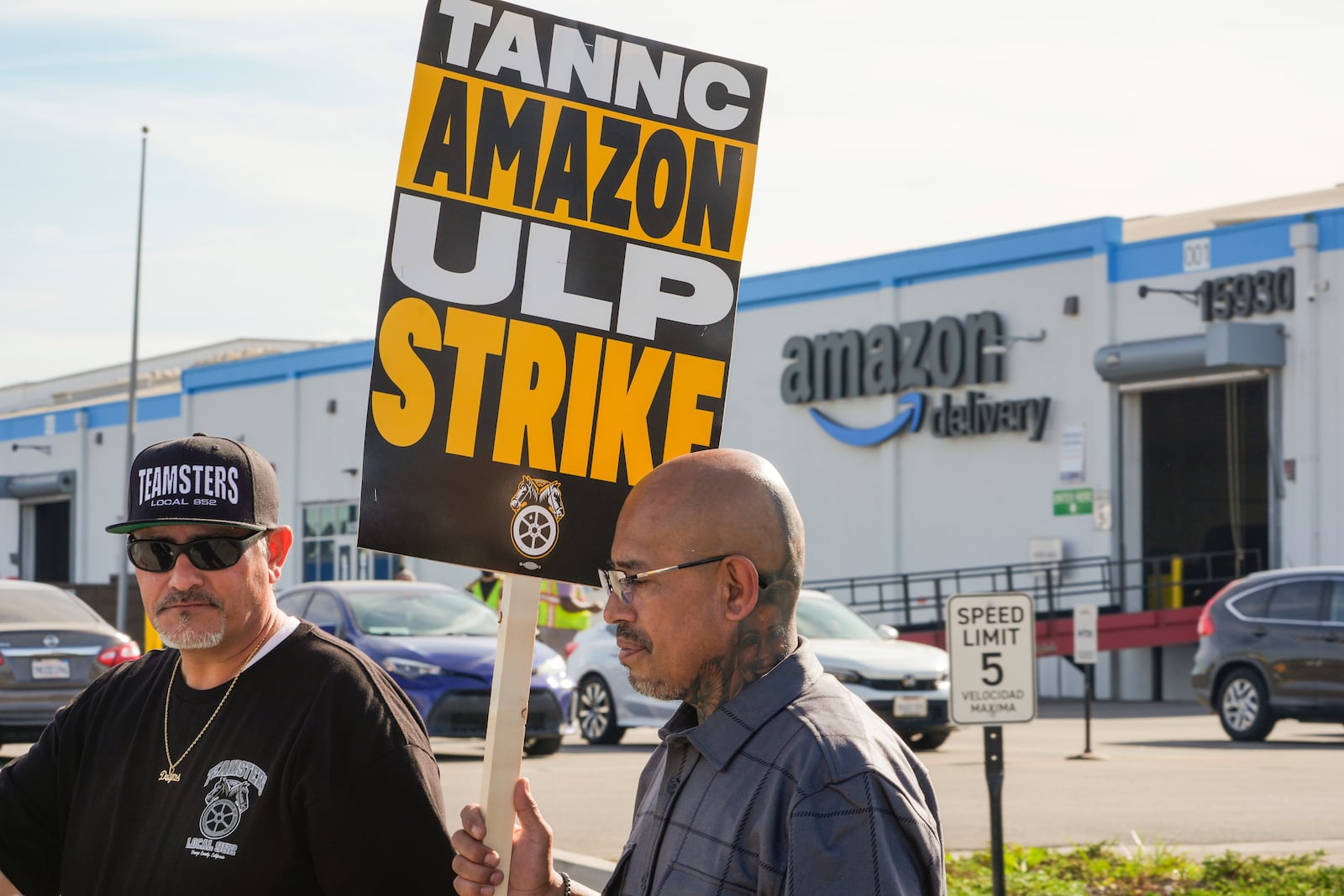 Amazon workers, on strike, picket outside an Amazon Fulfillment Center, Thursday, Dec. 19, 2024, in City of Industry, Calif. (AP Photo/Damian Dovarganes)