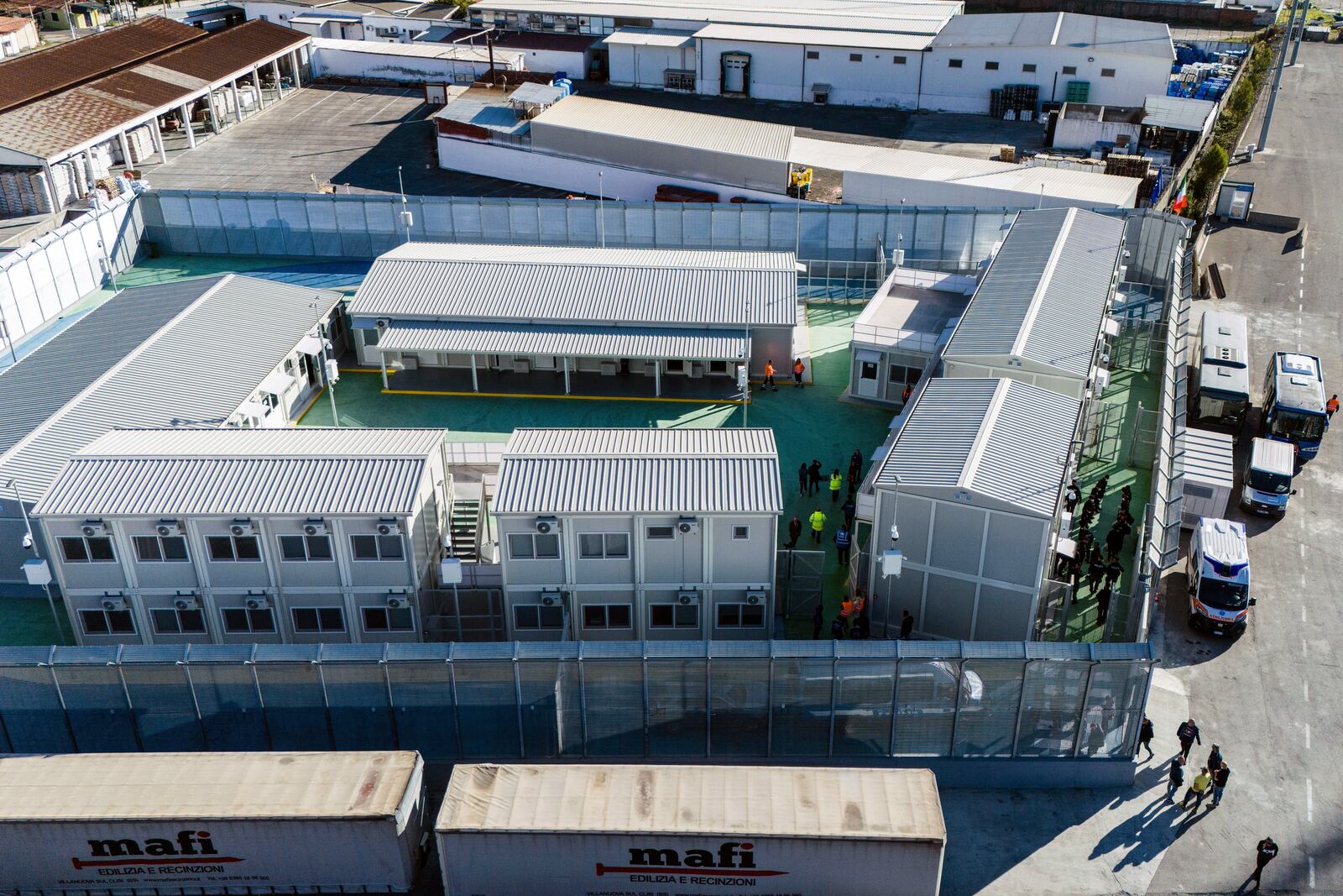 An aerial view of a migrant reception facility at the port of Shengjin, northwestern Albania, Friday, Nov. 8, 2024, before a second group of eight migrants intercepted in international waters is processed to the facility despite the failure with the first group in October. (AP Photo/Vlasov Sulaj)