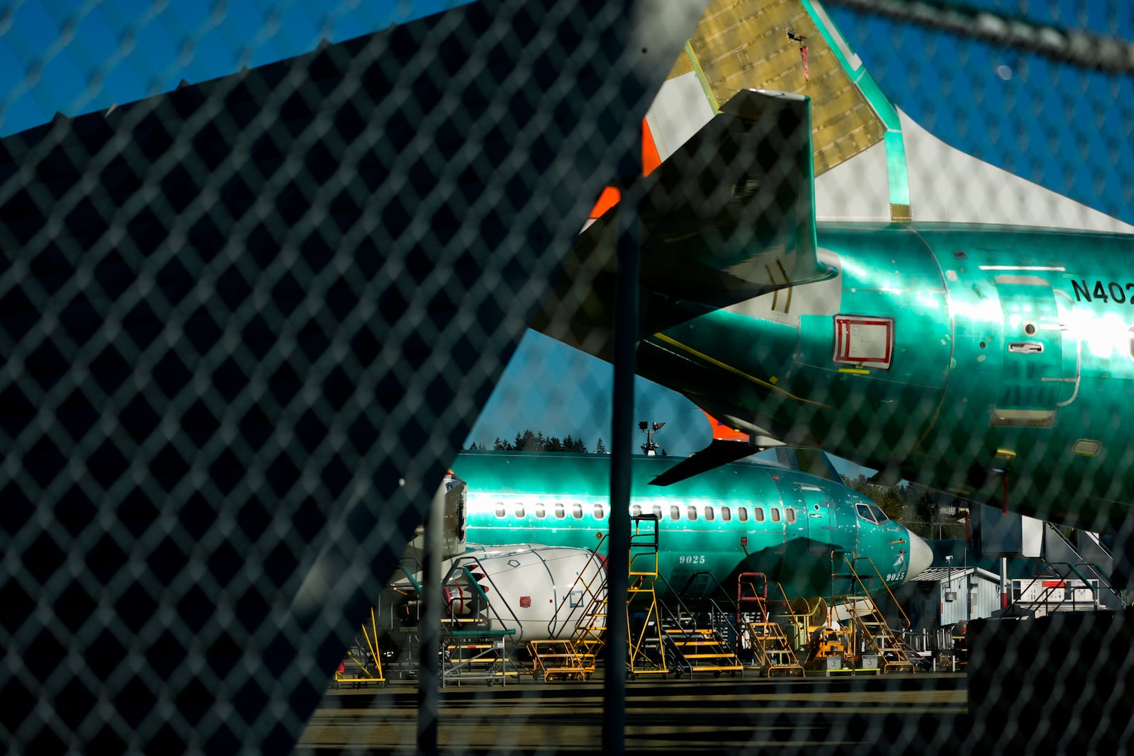 Boeing 737 Max aircrafts are seen behind fences, Tuesday, Sept. 24, 2024, at the company's facilities in Renton, Wash. (AP Photo/Lindsey Wasson)