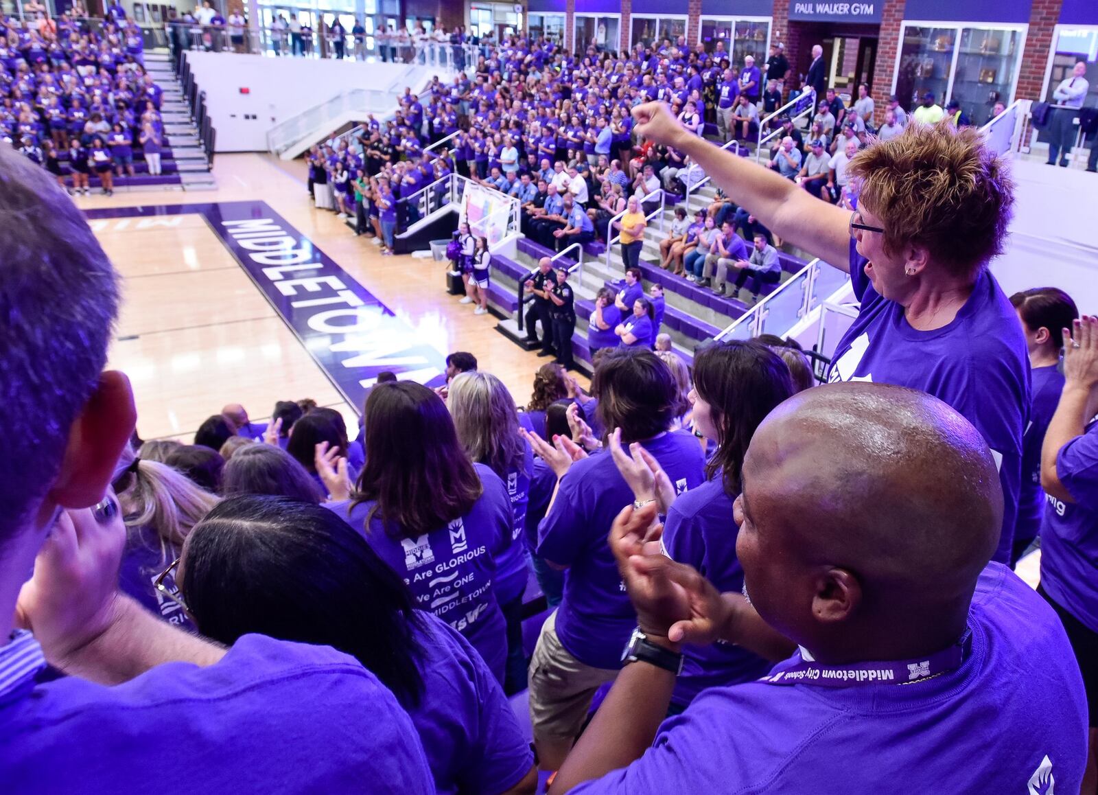 Cheryl Wyatt, right, a math teacher at Highview Sixth Grade Center, cheers during the back-to-school pep rally for Middletown City Schools teachers and staff. 