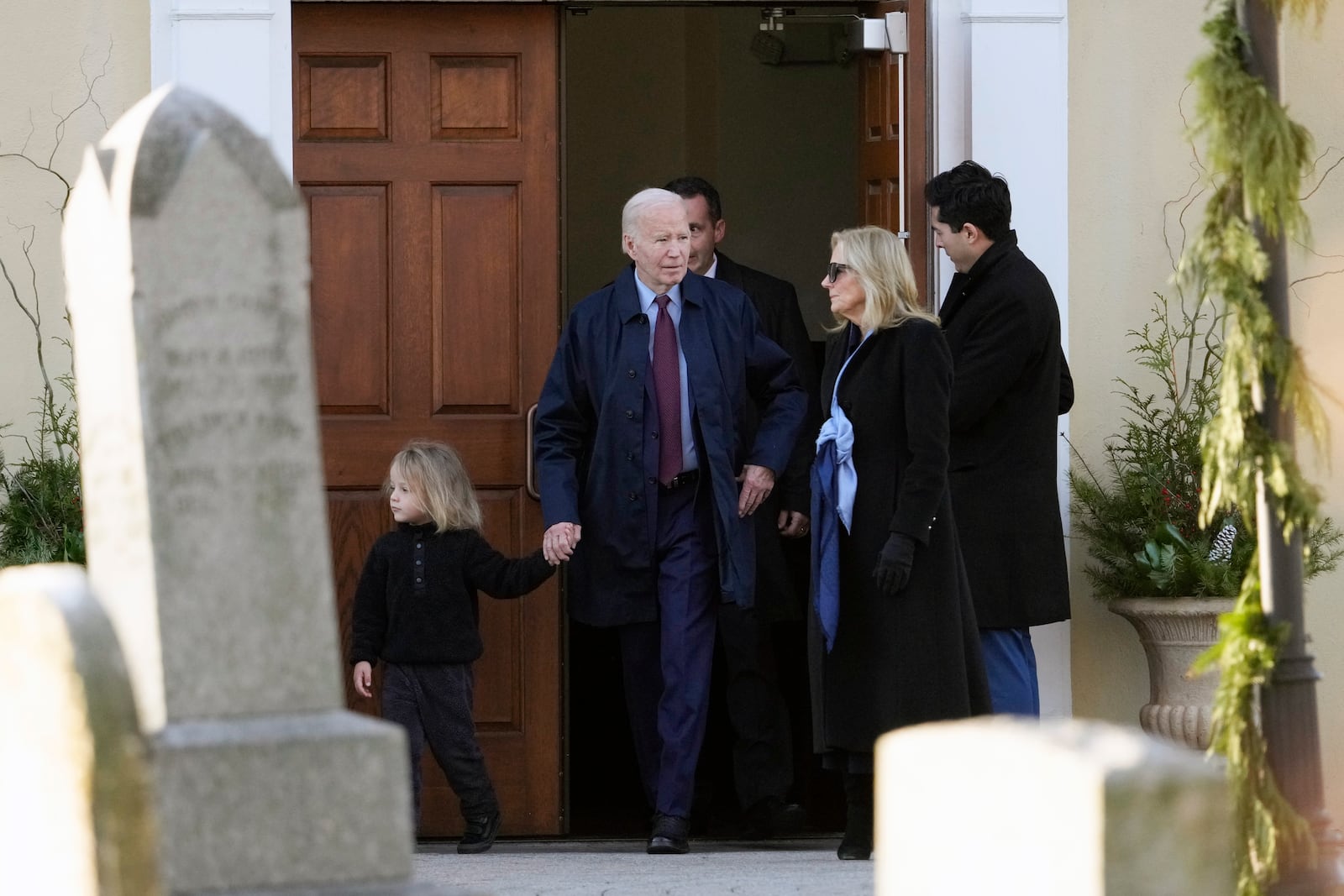 President Joe Biden, first lady Jill Biden and grandson Beau Biden step out of Brandywine Catholic Church in Wilmington, Del., on Wednesday, Dec. 18, 2024. Wednesday marks the 52nd anniversary of the car crash that killed Joe Biden's first wife Neilia Hunter Biden and 13-month-old daughter Naomi. (AP Photo/Ben Curtis)