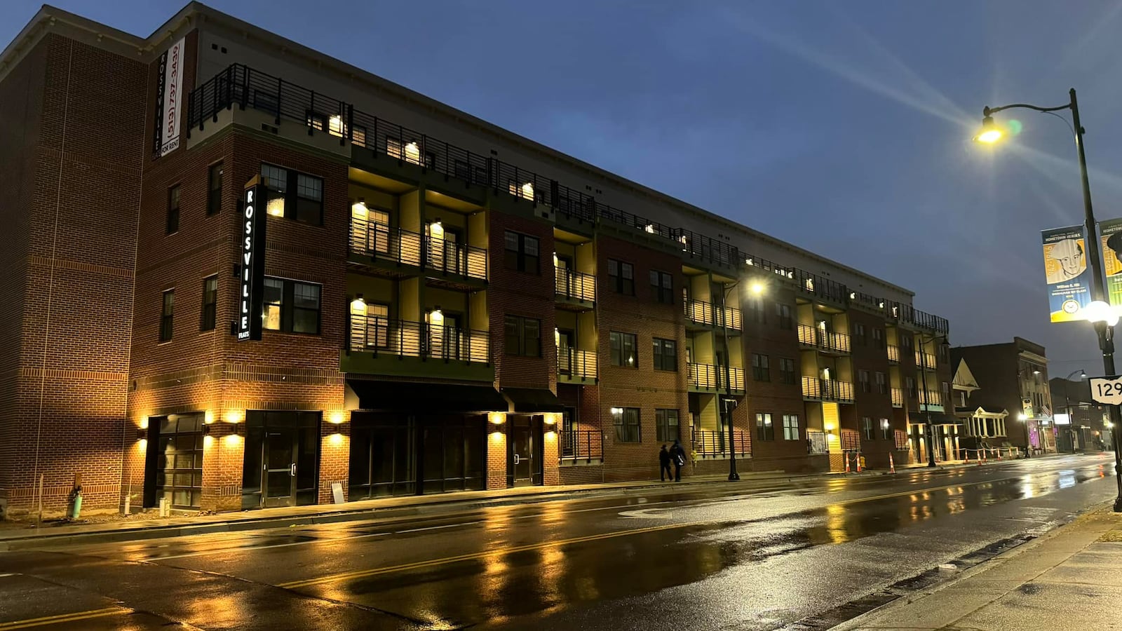 The new Rossville Flats apartments on Main Street in Hamilton is seen at night Oct. 5, 2023, the day the sign was placed on the building. MICHAEL D. PITMAN/STAFF