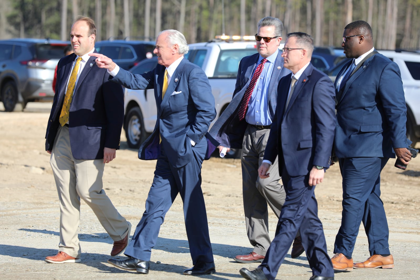 South Carolina Republican Gov. Henry McMaste points as he walks with his staff to a groundbreaking ceremony for a new interstate exit for the Scout Motors plant on Monday, Feb. 3, 2025, in Blythewood, S.C. (AP Photo/Jeffrey Collins)